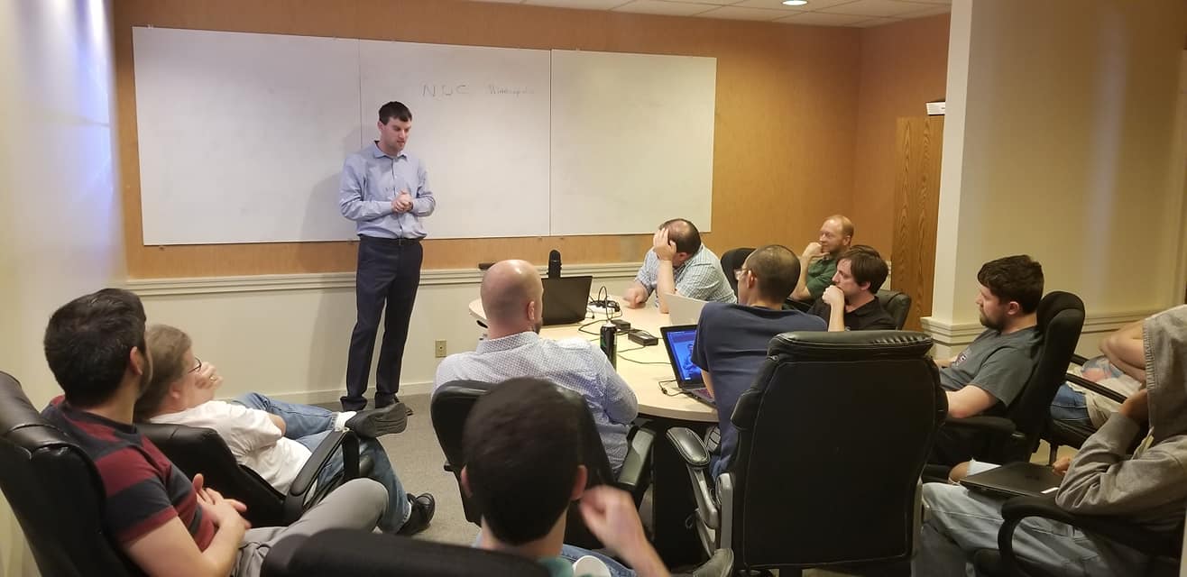 Tyson presenting programming ideas to a room of programmers
